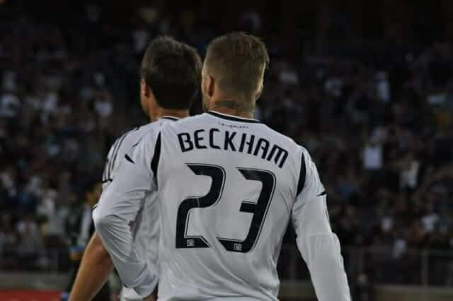 David Beckham on the soccer field, wearing jersey number 23 with his name on the back
