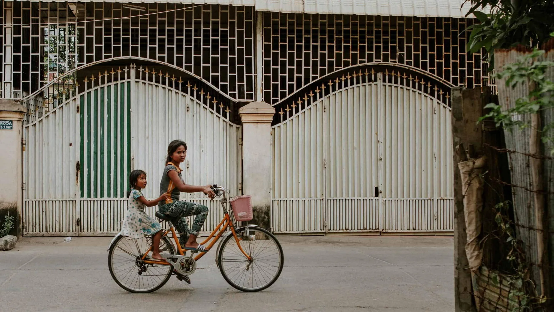 two cambodian girls on a bicycle together in Phnom Penh Cambodia